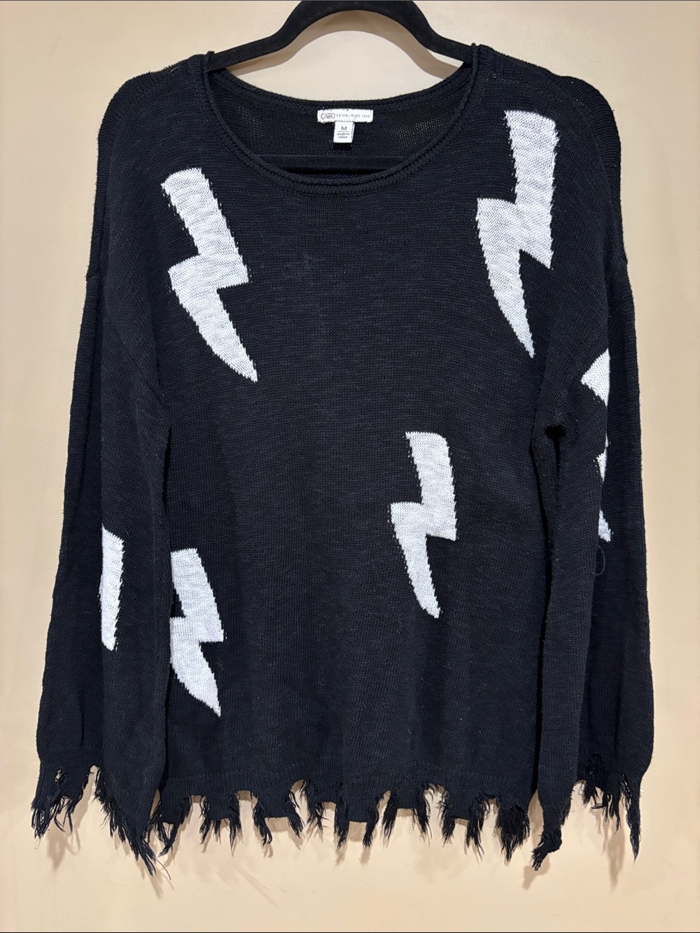 Black and white lightning bolt raw hem sweater
